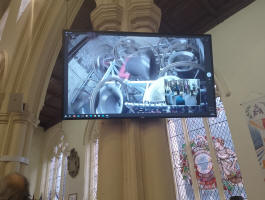 Screen relaying the bells and ringers during Stowmarket's rededication.