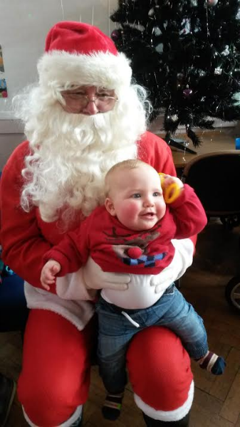 Alfie meeting Father Christmas at the Children Centre's Christmas party.