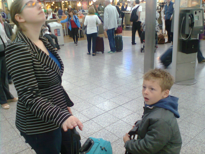 Ruthie and Mason inspecting the departure boards at Stansted Airport.