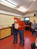Julian Colman accepting the 3rd place certificate on behalf of The Norman Tower from Diana Pipe.