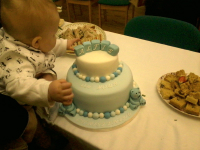 Alfie admires his Christening cake.