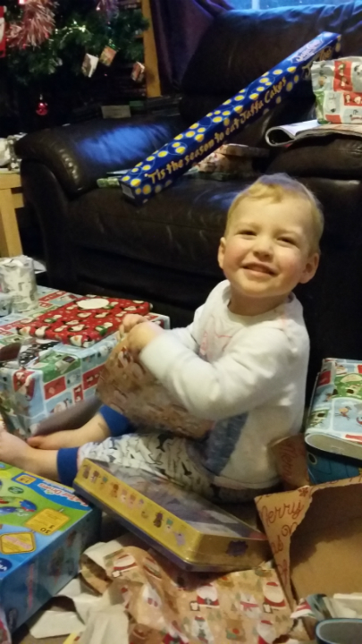  Alfie gets stuck into his presents.