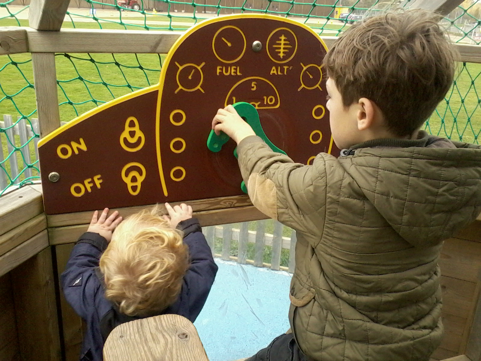 Alfie & Mason 'flying' a plane at Duxford's playground.