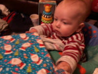 Joshua eyes his presents with suspicion.