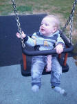 Joshua enjoying his first go on a swing!