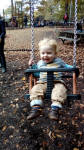 Joshua on the swings at Chatsworth House's adventure playground.