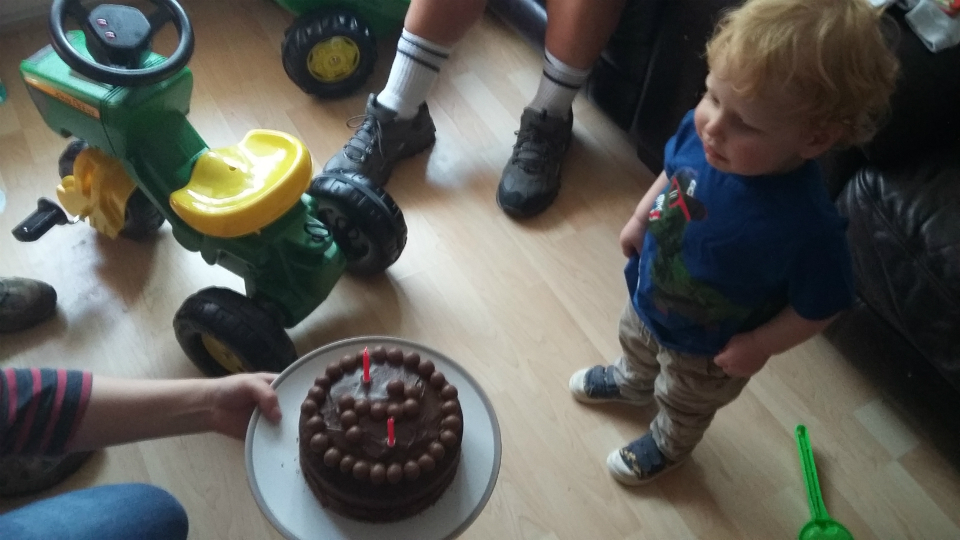 Joshua blowing out the candles on his birthday cake.