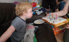 Joshua blowing out the candles on his birthday cake.
