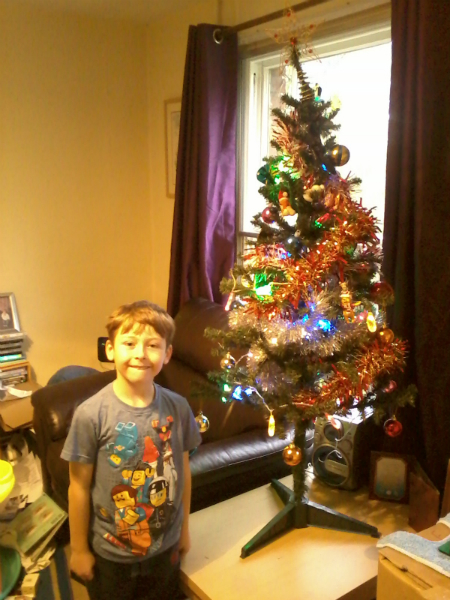 Mason next to our Christmas tree.