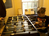Mason playing on his new table-football at ours.