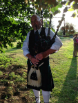 Ron playing the bagpipes in Pettistree churchyard.