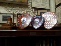 Trophies at St Mary-le-Tower. From l to r; the Cecil Pipe Memorial Bell (for the SE District Method Six-Bell Competition), the David Barnard Memorial Trophy (for the SE District Call-Change Six-Bell), George W Pipe Trophy (for the Essex and Suffolk Twelve-Bell Competition) and the Mitson Shield (for last year’s Guild Six-Bell).