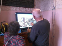Mike Cowling using the live feed to the bells to explain ringing to a visitor on the tower open day.