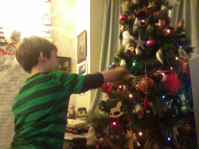 Mason plucking presents from his Nanna and Granddad's Christmas tree.