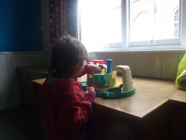 Mason takes advantage of the toys in the 'Toy Library' at St Mary's Church Hall.