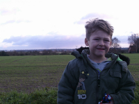 Mason shows off his latest haircut outside Harkstead church, with the River Stour and Essex in the distance.