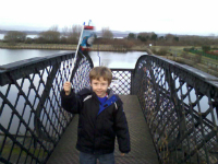 Mason with his new Thomas the Tank Engine flag on the bridge over the Bo'ness & Kinneil Railway.