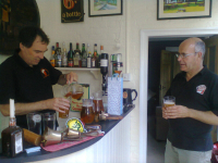 Neil getting a beer from the host at the bar in Philip & Maggie's house.