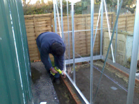 Ron putting the greenhouse up.