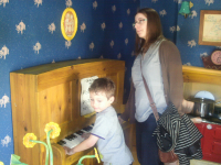 Ruthie and Mason playing the piano with the Three Little Pigs.